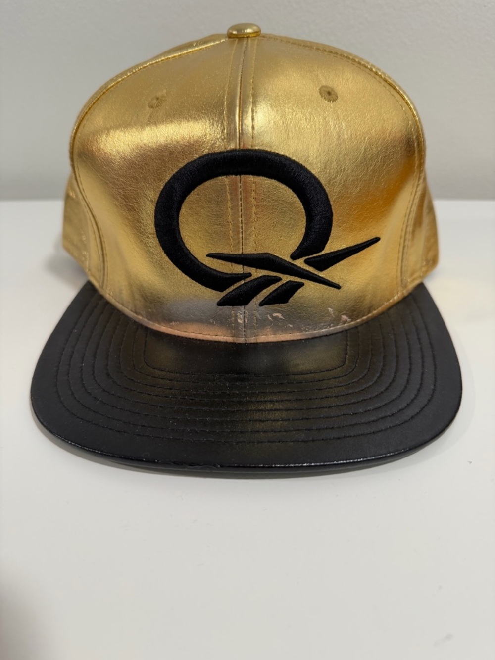 Reebok question Gold and Black Metallic Snapback Hat with Embroidered Logo